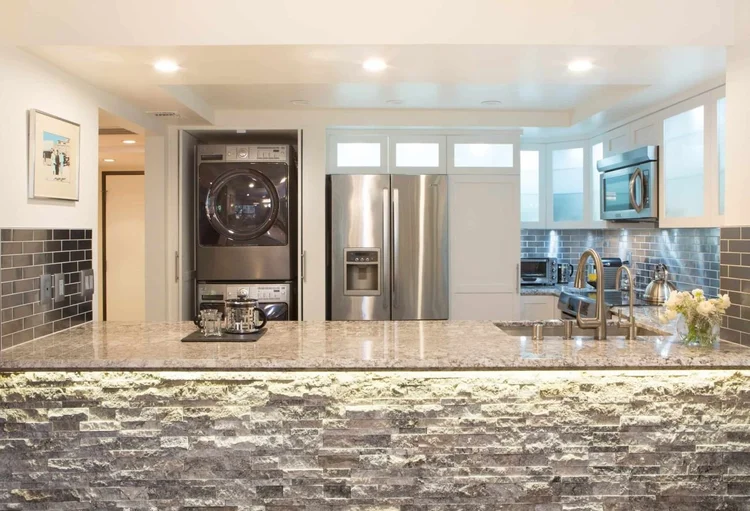 white shaker kitchen with stackable washer and dryer, Wilshire Corridor